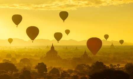 Hot air balloon over plain of Bagan in misty morning, Myanmarの写真素材