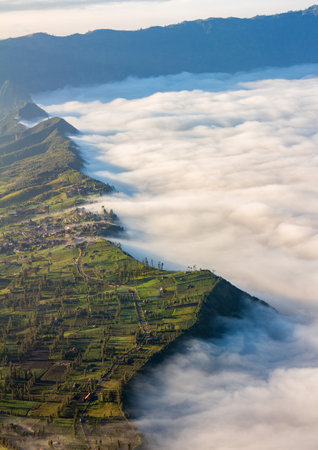 Village and Cliff at Bromo Volcano in Tengger Semeru national park, Java, Indonesiaの写真素材