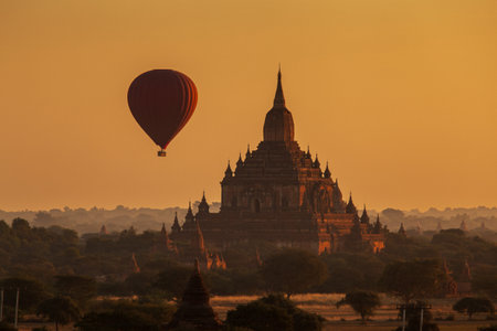 Hot air balloon over plain of Bagan in misty morning, Myanmarの写真素材