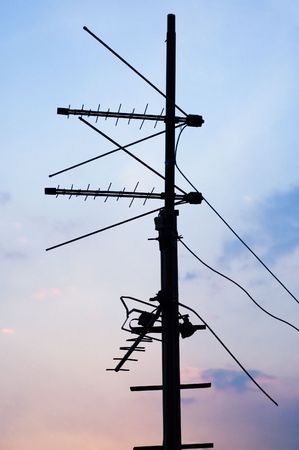 TV and communication aerials on roof of residential houseの写真素材