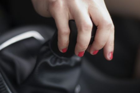 Girl switching speed by lever in carの写真素材