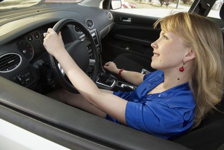 Driving young fun woman with smile