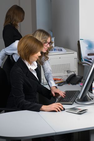 Businesswoman working in front of computer with her colleguesの写真素材