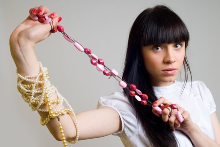 Portrait of beautiful  young woman with beadsの写真素材