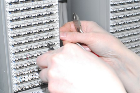 Woman working on technical site of mobile switching center for connection cellular phones