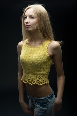 Young woman in studio at black backgroundの写真素材