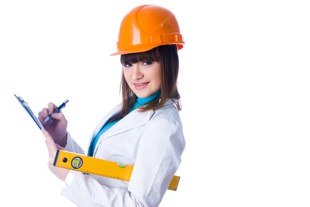 Young female worker with protection helmet and level at isolated backgroundの写真素材