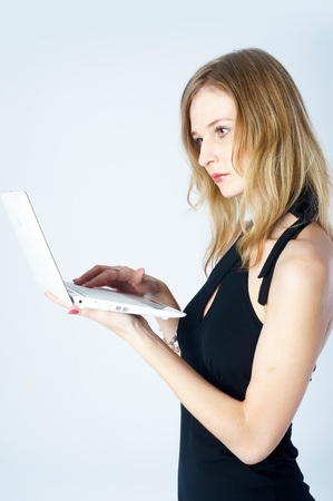 Attractive blonde girl with laptopの写真素材
