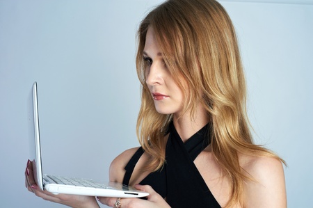 Attractive blonde girl with laptopの写真素材