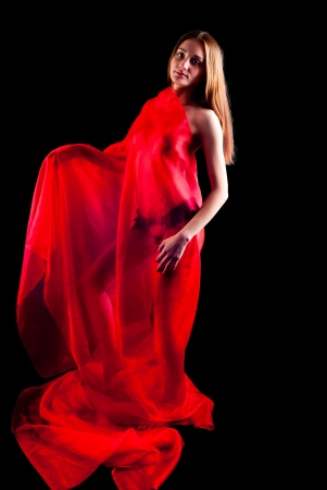 Young beautiful nude woman in red scarf  Isolated on blackの写真素材