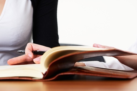 business woman writes mission for business plan