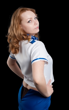 Attractive young stewardess isolated over black backgroundの写真素材