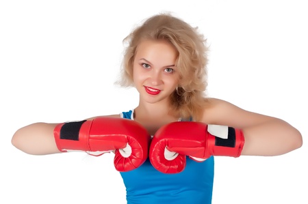 Young blonde woman with boxing gloves isolated on white backgroundの写真素材