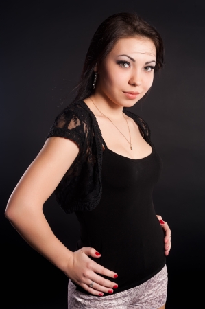 young brunette woman beauty portrait at black backgroundの写真素材