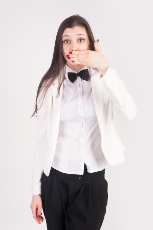 Young businesswoman covering her mouth with her handの写真素材