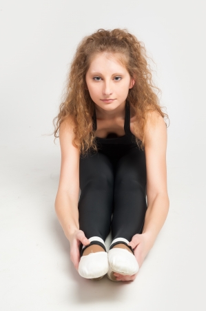 Happy beautiful slim woman doing fitness at white backgroundの写真素材