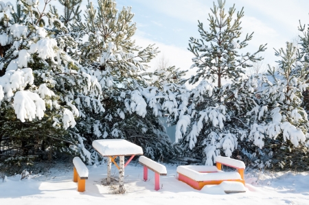 Beautiful winter landscape with snow covered trees and benchesの写真素材