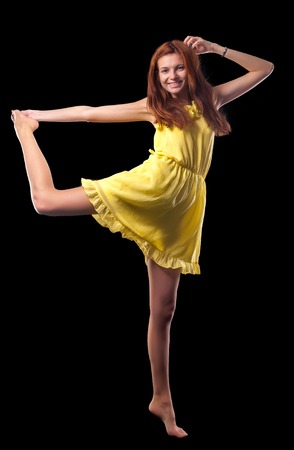 Young attractive woman is engaged in fitness at black backgroundの写真素材