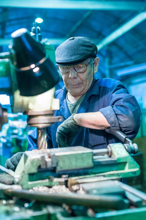 Tyumen, Russia - September 7, 2010  JSC Tyumenskie Motorostroiteli  Plant on production and repair of aviation engines   Milling-machine operator works at the machineのeditorial素材