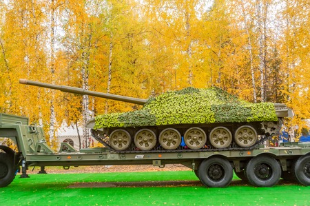 Nizhniy Tagil, Russia - September 27  2013  Russia Arms Expo-2013 exhibition  Tank under camouflage network on truck platformのeditorial素材
