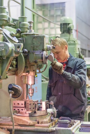 Tyumen, Russia - November 14, 2007  JSC Tyumenskie Motorostroiteli  Plant on production and repair of aviation engines   Worker drills bores on detail by drillerのeditorial素材