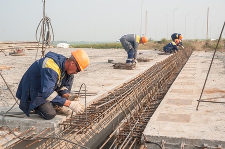 Tyumen, Russia - July 31, 2013  JSC Mostostroy-11  Bridge construction for outcome of the Tobolsk path and Bypass road round Tyumen  Workers make fittings bindingon on bridge constructionのeditorial素材