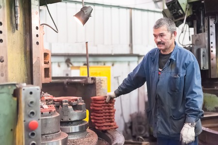 Tyumen, Russia - September 7, 2010  JSC Tyumenskie Motorostroiteli  Plant on production and repair of aviation engines   Milling-machine operator works at the machineのeditorial素材