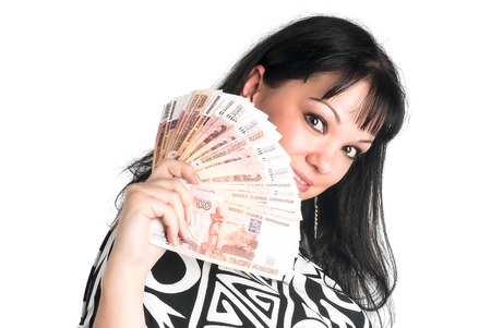 Young attractive woman with currency over white backgroundの写真素材