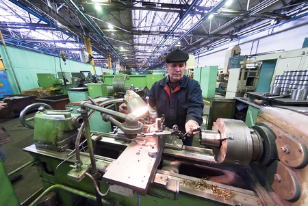 Tyumen, Russia - November 14, 2007: JSC Tyumenskie Motorostroiteli (Plant on production and repair of aviation engines). Senior milling machine operator works at machineのeditorial素材
