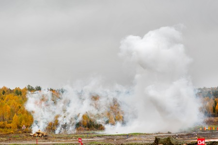 Nizhniy Tagil, Russia - September 27. 2013: Russian tank T-90 hides in smoke screen from enemy, Display of fighting opportunities of arms and military equipment. RAE-2013 exhibitionのeditorial素材