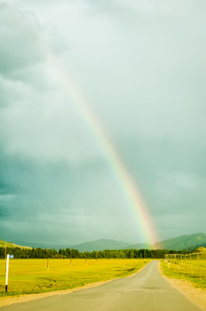 Summer rainbow above road in Mountain Altai. Russiaの写真素材