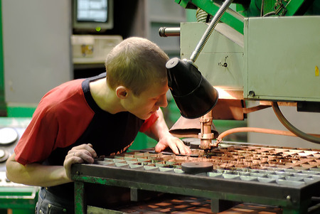 Tyumen, Russia - November 14, 2007: JSC Tyumenskie Motorostroiteli (Plant on production and repair of aviation engines). Milling-machine operator works at machineのeditorial素材