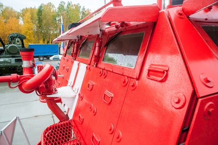 Nizhniy Tagil, Russia - September 25. 2013: Visitors explore military and special equipment on exhibition range. Special fire fighting vehicle SPM. Russia Arms Expo-2013 exhibitionのeditorial素材