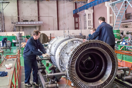 Tyumen, Russia - November 14, 2007: JSC Tyumenskie Motorostroiteli (Plant on production and repair of aviation engines). Workers assemble turbine of aviation engineのeditorial素材