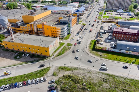Tyumen, Russia - May 19, 2015: Aerial view on Permyakova and Harkovskaya streets intersection. On foreground: Beer-nonalcoholic combine "Ochakovo", Perestroyka trade centerのeditorial素材