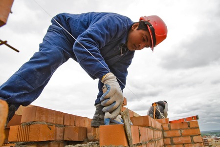 Tyumen, Russia - May 23, 2008: Construction of 18 floor brick residental house at intersection of streets of Gercena and Chelyuskincev. Bricklayer behind work. It is demolished because of bad baseのeditorial素材