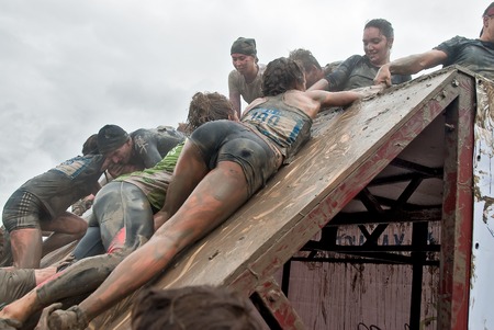 Tyumen, Russia - August 8, 2015: Steel Character command extrim race project on Krugloe lake and Gagarin park.  Stage - rise on high inclined wall. Teams storm a wallのeditorial素材