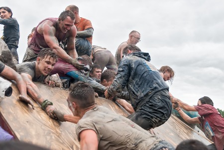 Tyumen, Russia - August 8, 2015: Steel Character command extrim race project on Krugloe lake and Gagarin park.  Stage - rise on high inclined wall. Teams storm a wallのeditorial素材