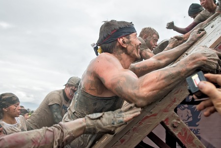Tyumen, Russia - August 8, 2015: Steel Character command extrim race project on Krugloe lake and Gagarin park.  Stage - rise on high inclined wall. Teams storm a wallのeditorial素材