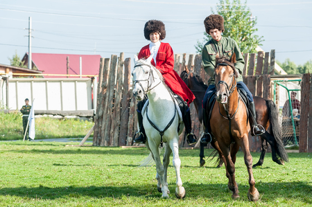Tyumen, Russia - September 22, 2012: Avanpost training center on preparation of school students for army. Miles of Fire festival of live history.  Show of Cossacks on horsesのeditorial素材