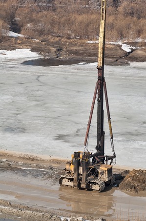 Tyumen, Russia - March 29, 2008: Construction equipment on building construction of pedestrian quay on Tura river  Diesel pile driving machineのeditorial素材