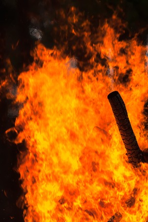 Disaster with wooden house. Big fire over dark background