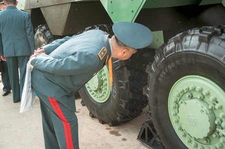 Nizhniy Tagil, Russia - September 25. 2013: Officers of Kazakh army examine armored troop-carrier of joint Russian-French production. RAE-2013 exhibition. Russian Arms Expoのeditorial素材