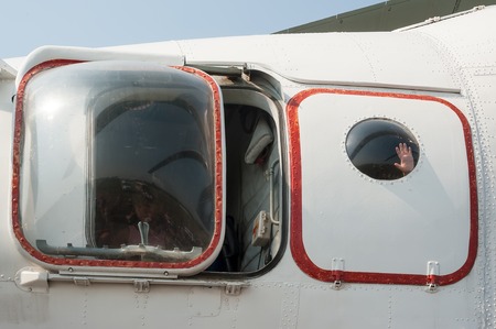 Tyumen, Russia - August 11, 2012: Air show "On a visit at UTair" in heliport Plehanovo. Visitors explore cabin of MI-26T helicopter. Hand in illuminatorのeditorial素材