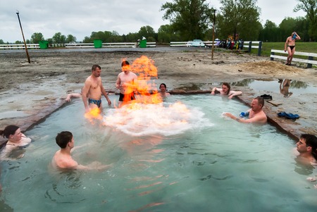 Sungurovo, Russia - May 25, 2008: Mineral water spring Beryozovka. People rest at geothermal hot water bath with sulfuric gas source. Burning gas. Tyumen regionのeditorial素材