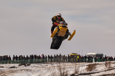 Tyumen, Russia - March 08. 2008: IV stage of personal-team Championship of Ural Federal district in over-snow cross-country. Jumping of sportsman on snowmobileのeditorial素材