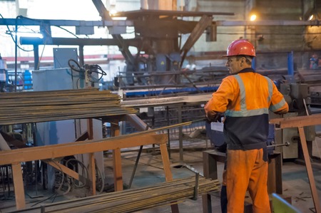 Tyumen, Russia - August 13, 2013: Block making department at construction material factory ZHBI-5. Worker in reinforcing shopのeditorial素材