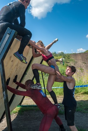 Tyumen, Russia - July 9, 2016: Steel Character extrim race on Voronino Hill. Athletes climb on inclined wallのeditorial素材