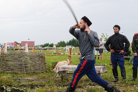 Tyumen, Russia - June 24, 2016: The 5th open championship of Russia on a plowed land. Cossack shows skill of sabre possessionのeditorial素材