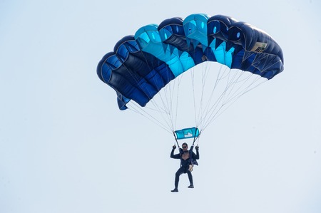 Tyumen, Russia - August 11, 2012: On a visit at UTair air show in heliport Plehanovo. Paratrooper man landing in show programのeditorial素材